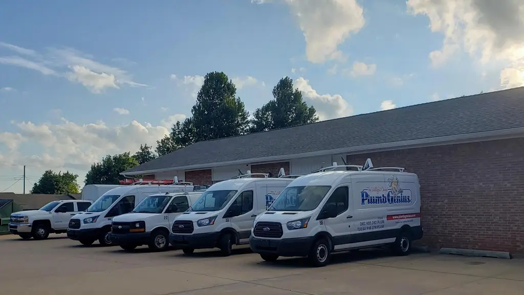 The Plumb Genius fleet of branded vans lined up outside their shop in evening light